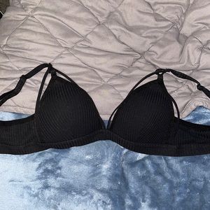 Small black bralette with straps and push up padding